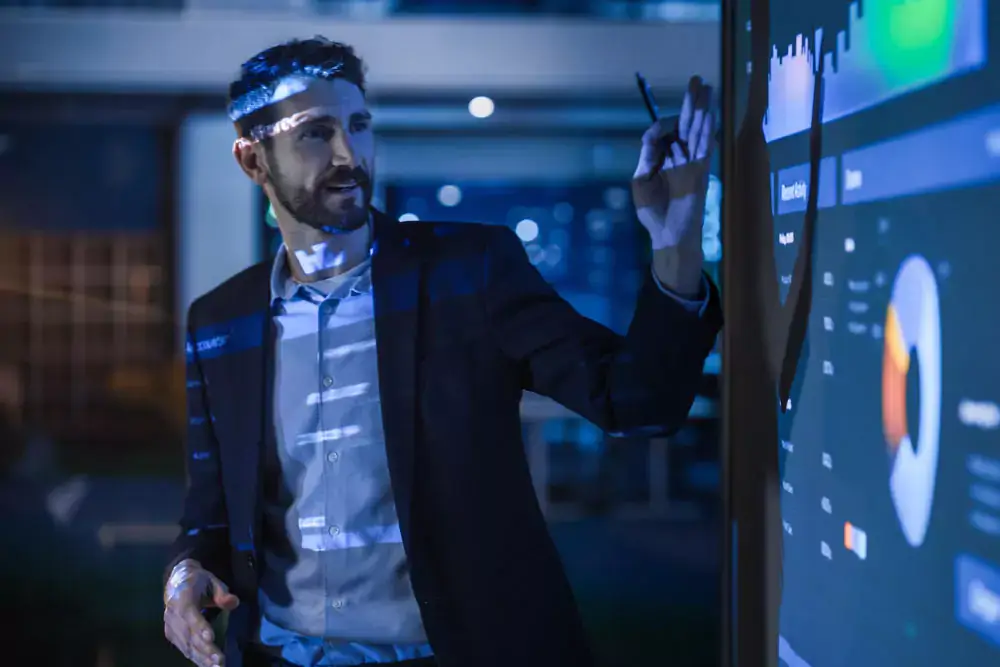 Conference business meeting presentation: CEO businessman shows data to group of investors